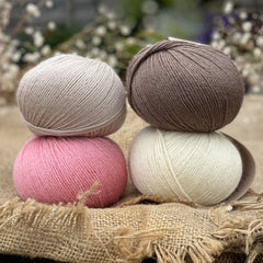 Four balls or Milburn. On the top row is a beige ball and a brown ball. On the bottom row is a pink ball and a cream ball