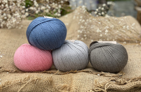 Four balls of Milburn. From left to right: a pink ball, a blue ball, a pale blue ball and a grey ball