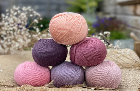 Six balls of Milburn 4ply in shades or pink and purple