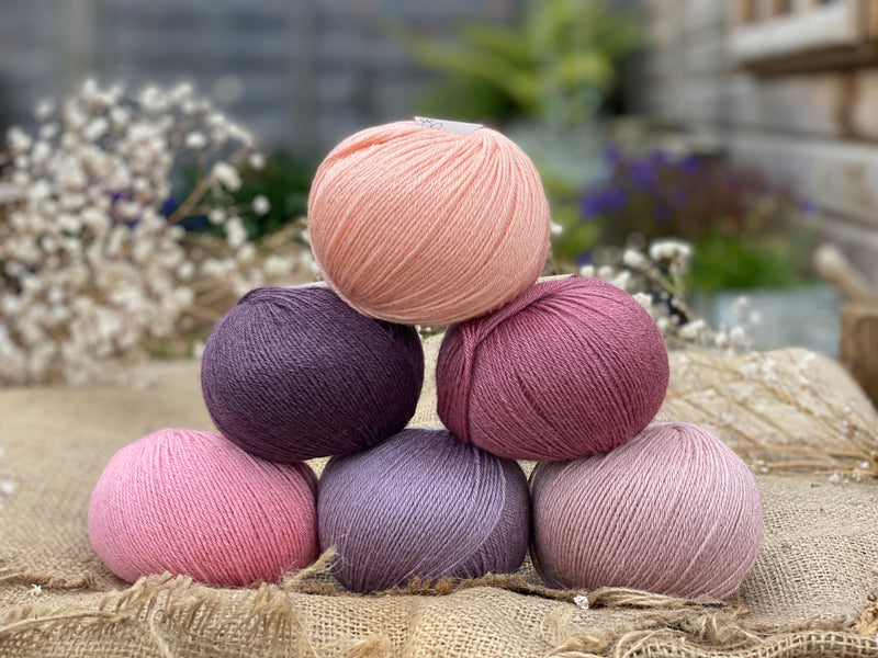 Six balls of Milburn 4ply in shades or pink and purple