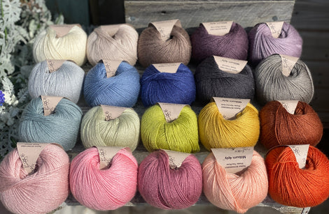 Twenty balls of yarn arranged in four rows of five. All twenty colours of the Milburn range are shown