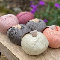 Six balls of yarn in grey and pinks