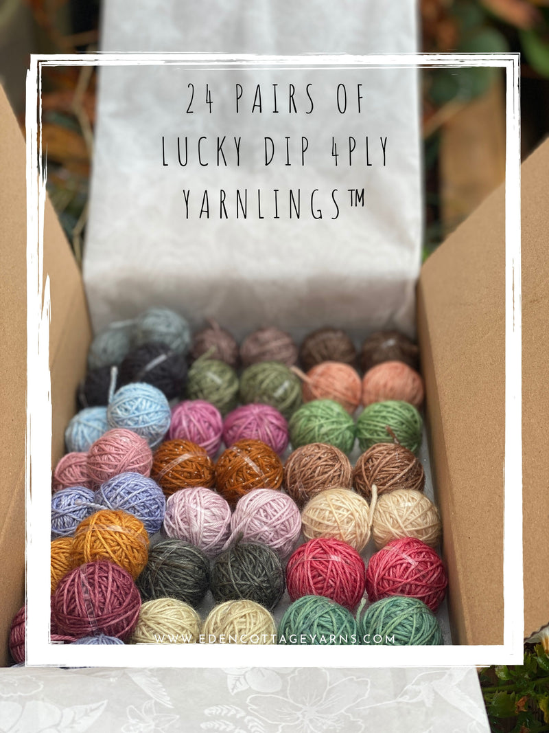 A box of 24 Yarnling pairs. Text at the top of the image is "24 pairs of Lucky Dip 4ply Yarnlings"