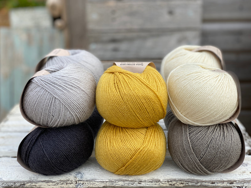 Ten balls of Milburn in shades of grey with a pop of yellow
