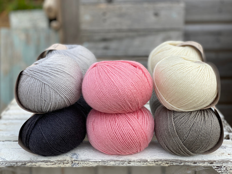 10 balls of Milburn in shades of grey with a pop of pink