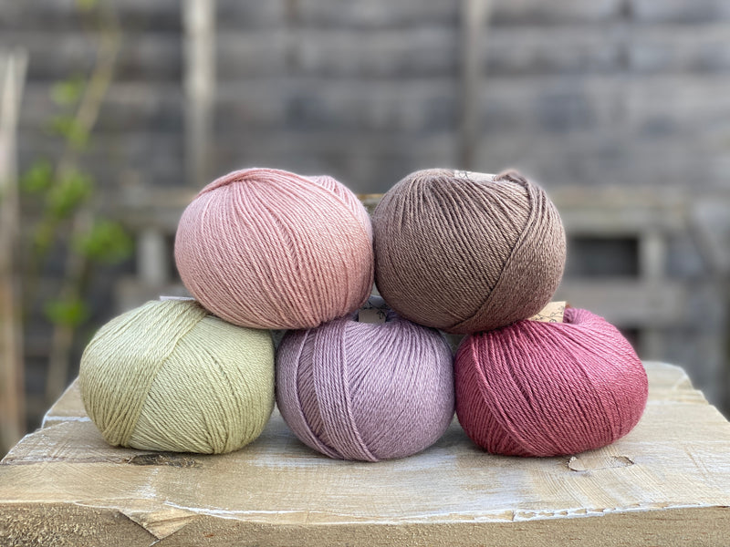 Five balls of Milburn in shades of pink, purple, green and brown