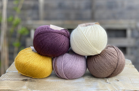 Five balls of Milburn in shades of purple, cream, yellow and brown