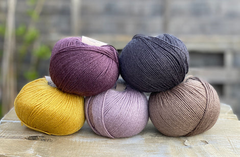 Five balls of Milburn in purple, black , brown and yellow