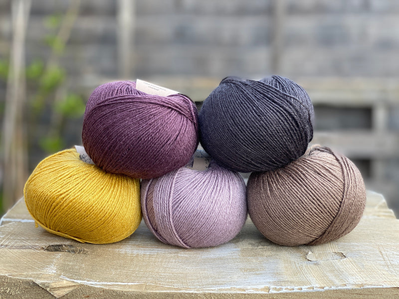 Five balls of Milburn in purple, black , brown and yellow