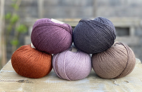 Milburn 4ply in shades of purple, black, brown and rust