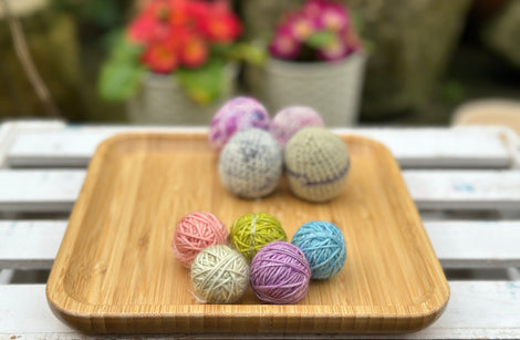 Five tiny balls of yarn in floral colours