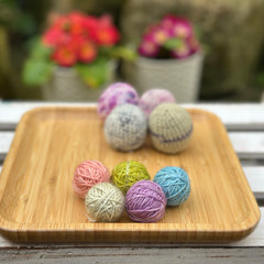 Five tiny balls of yarn in floral colours
