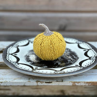 a knitted pumpkin in Milburn DK in Harvest Gold