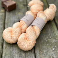 Two skeins of light orange yarn