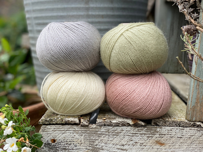 Four balls of Milburn. On the top row is a pale blue ball and a pale green ball. On the bottom row is a cream ball and a pale pink ball