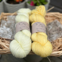 Two skeins of yarn in shades of yellow
