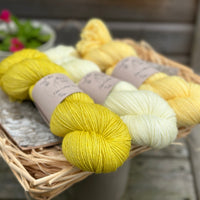 Three skeins of yarn in shades of yellow