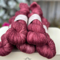 Five skeins of deep purpley red yarn