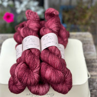 Five skeins of deep purpley red yarn