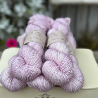 Five skeins of pale pink yarn