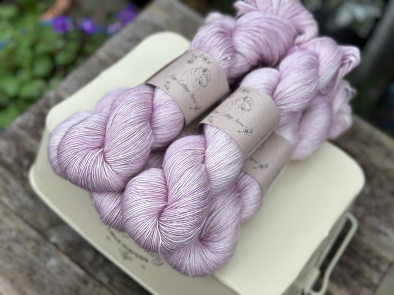 Five skeins of pale pink yarn