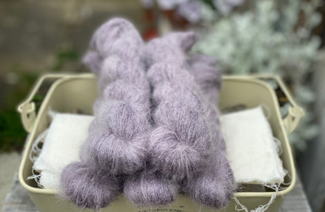 Five skeins of purple fluffy yarn