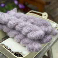 Five skeins of purple fluffy yarn