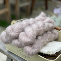 Five skeins of light brown fluffy yarn