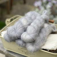 Five skeins of grey fluffy yarn
