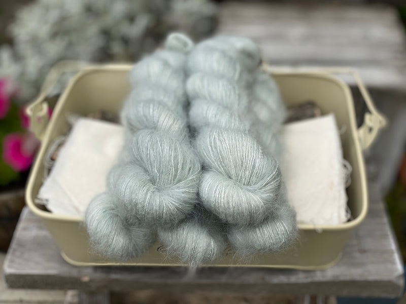 Five skeins of silvery grey fluffy yarn