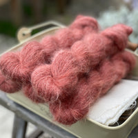 Five skeins of red fluffy yarn