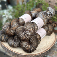 Five skeins of variegated brown and grey yarn