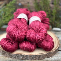 Five skeins of purpley red yarn
