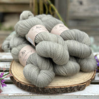 Five skeins of grey laceweight yarn