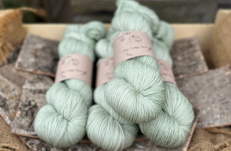 Four skeins of pale green yarn