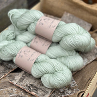 Four skeins of pale green yarn