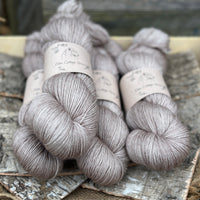 Four skeins of yarn in light brown