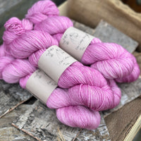 Five skeins of purpley pink yarn