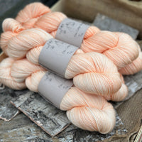 Five skeins of light orange yarn