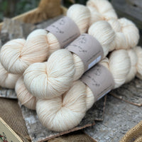 Five skeins of cream coloured yarn