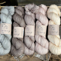 Five skeins of yarn in neutral shades