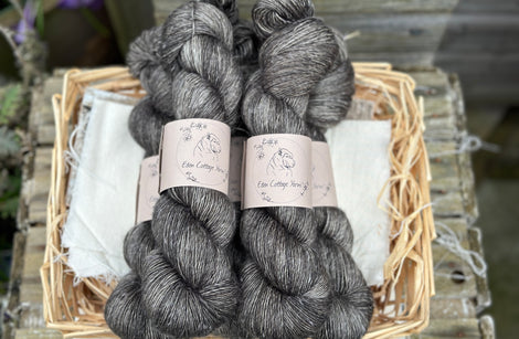 Five skeins of dark grey yarn