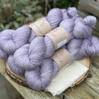 Five skeins of pale purple yarn with a silver sparkle running through it