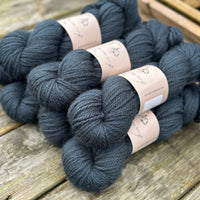 Seven skeins of dark blue yarn