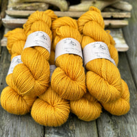 Seven skeins of rich yellow yarn