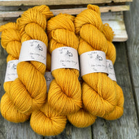 Seven skeins of rich yellow yarn