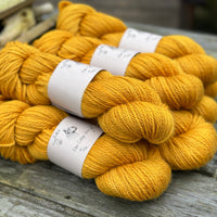 Seven skeins of rich yellow yarn