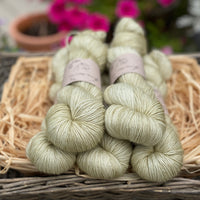 Five skeins of light brownish green yarn