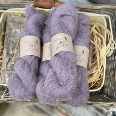 Four skeins of purple fluffy yarn
