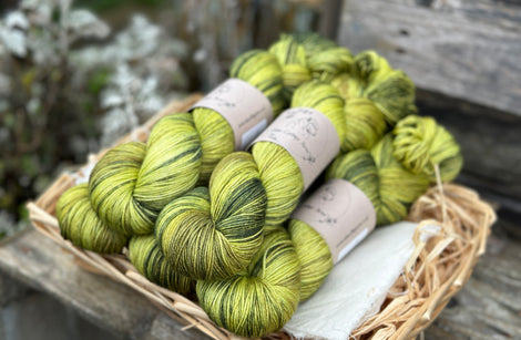 Five skeins of variegated green yarn